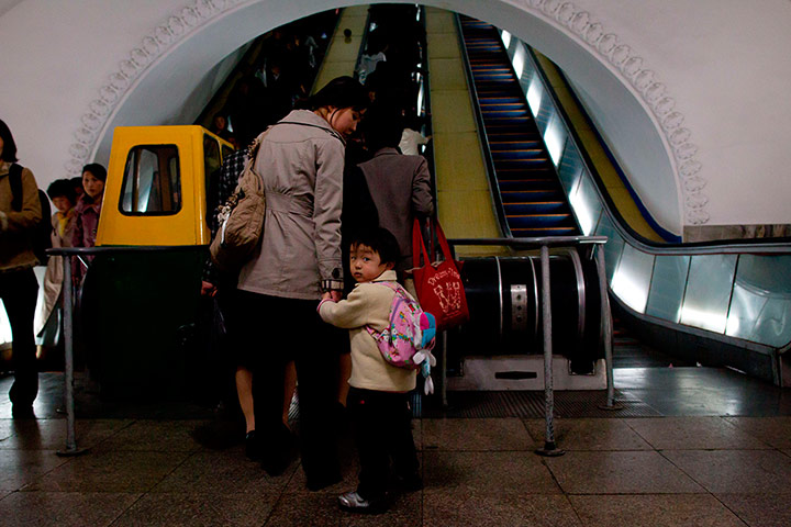 Longer view: Communters on the metro in Pyongyang