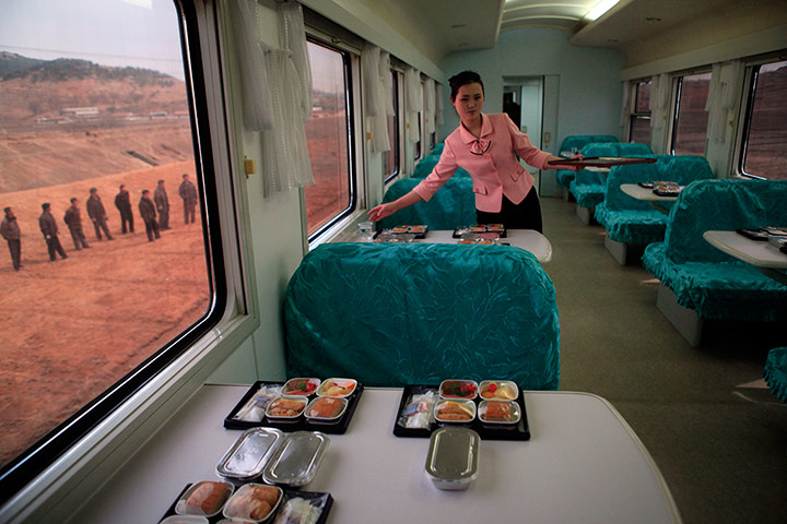 Longer view: A North Korean waitress serves packaged meals for lunch on a train