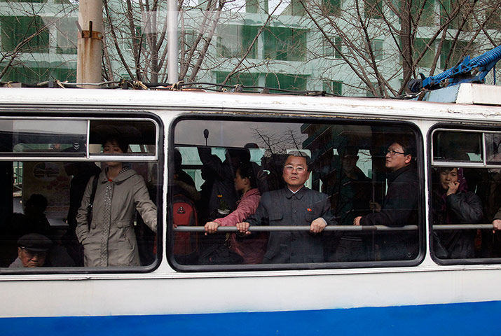 Longer view: A North Korean man looks out from the window of a public bus in Pyongyang