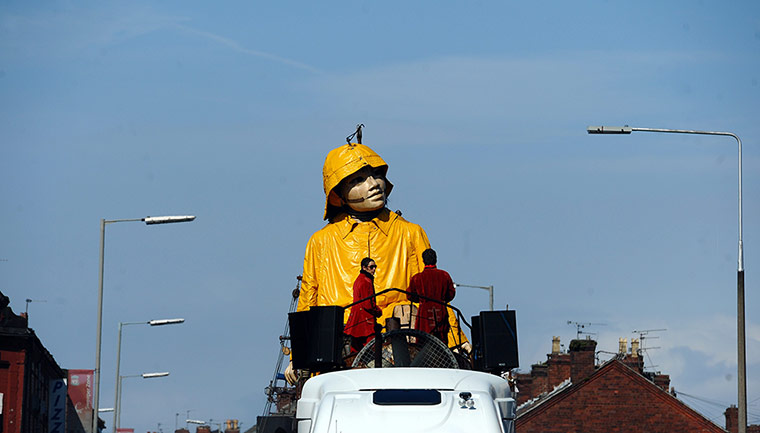 Liverpool Royal de Luxe: A giant puppet is prepared to be lifted from a boat outside Liverpool