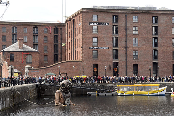 Liverpool Royal de Luxe: Giant Uncle puppet rises from the Albert Docks