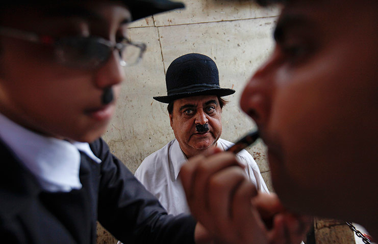 From the Agencies: Ashok Aswani watches as a member of his club has his make-up applied