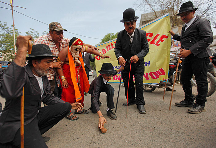 From the Agencies: Aswani watches as a member of the fan club breaks a coconut