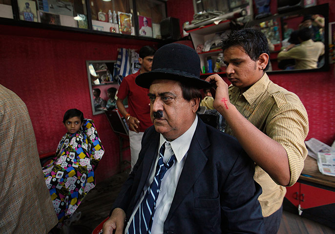 From the Agencies: Aswani has his Charlie Chaplin hat carefully positioned by his barber