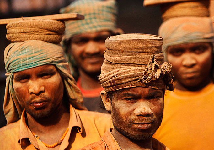 24 hours: Kathmandu, Nepal: Workers stand together at a brick factory in Imadol