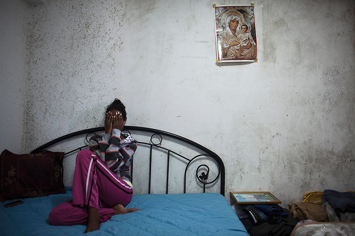 24 hours: Hrity, a migrant from Eritrea, covers her face 