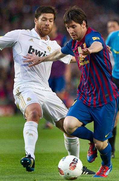 El Clasico: Lionel Messi protects the ball