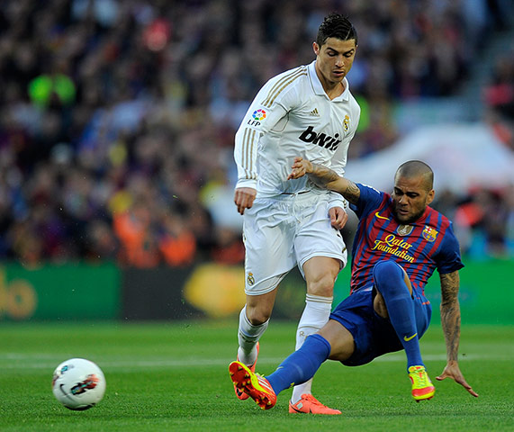 El Clasico: Dani Alves goes to ground under pressure from Ronaldo