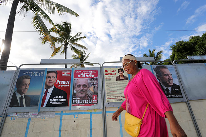 French elections: A woman passes campaign posters in La Possession, La Reunion