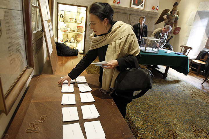 French elections: A woman takes her ballots before casting her vote in Mont Saint-Michel