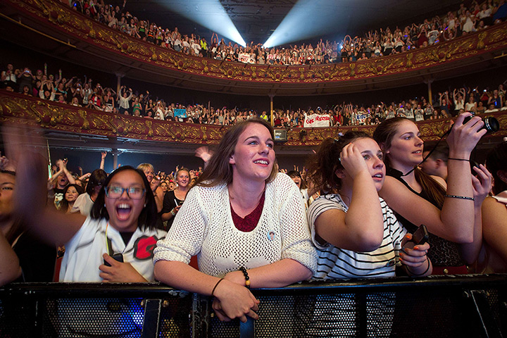 24 hours: Wellington, New Zealand: Fans watch as the boy band One Direction performs