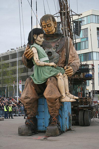 Liverpool Puppets: The little girl giant and her uncle hug after reuniting