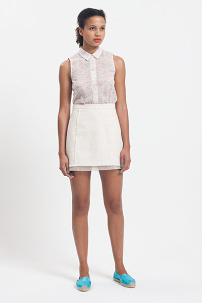 All Ages: Emily wears a floral blouse with a white skirt