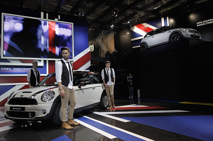 Beijing motor show: Models stands beside a Mini Cooper S car 