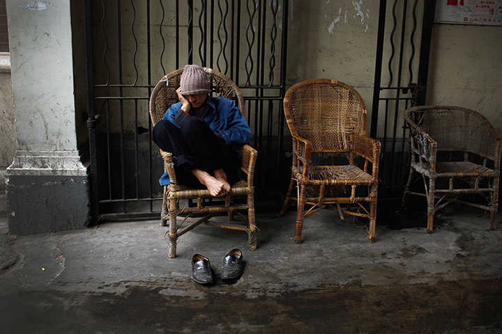 24 hours in pictures: Man dozes off in a chair in downtown Shanghai