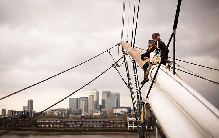 Cutty Sark photo call: Rigging sit on the mast as they work on the newly-restored Cutty Sark