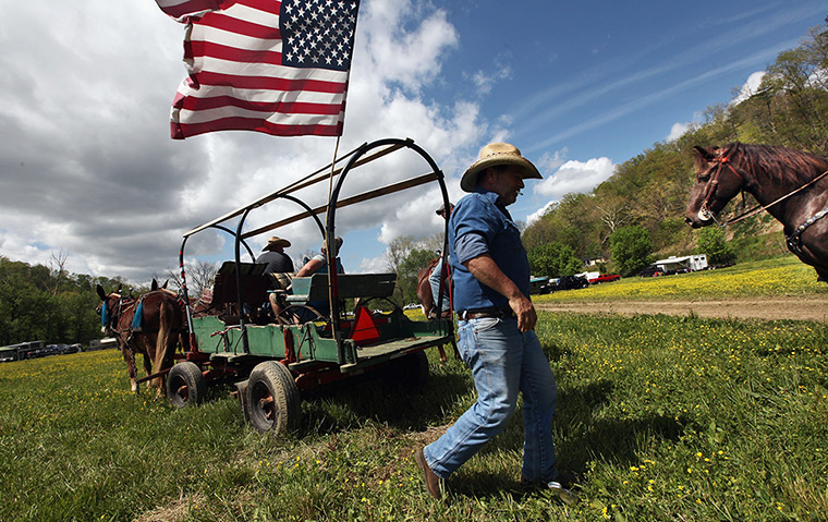 Booneville, Kentucky: A man walks by his carriage at the Owsley County Saddle Club trail ride