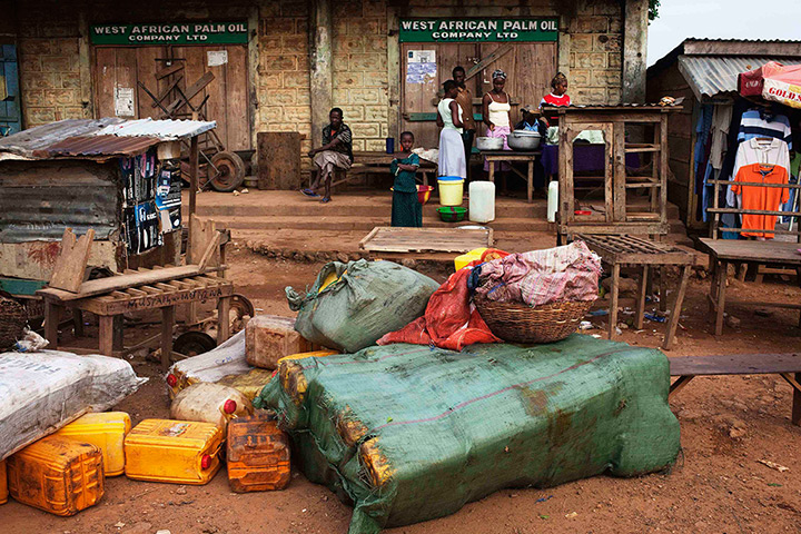 Sierra Leone after Taylor: Containers of palm oil lie in front of a store in the town of Kailahun