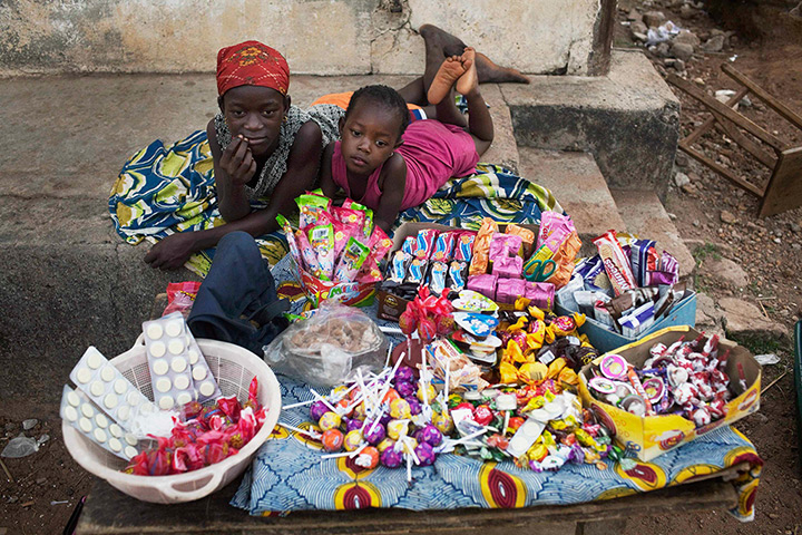 Sierra Leone after Taylor: Two girls sell sweets watch from their makeshift kiosk in Makeni 
