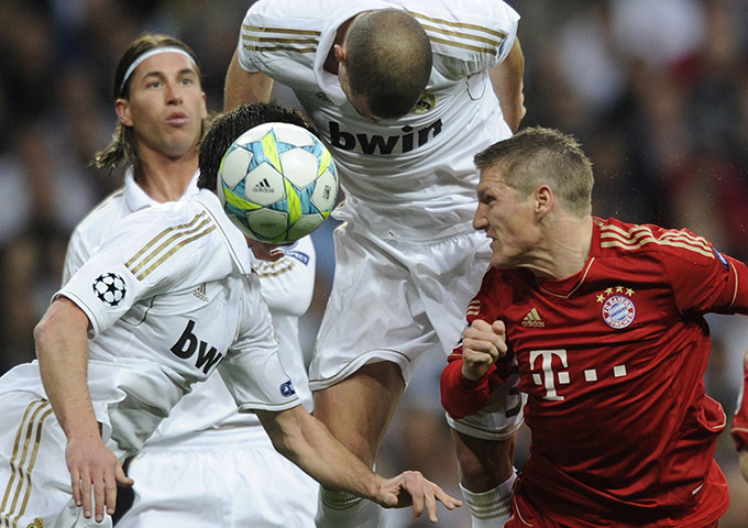 Real Madrid v Bayern: Pepe gets to the ball before Bastian Schweinsteiger to head the ball clear