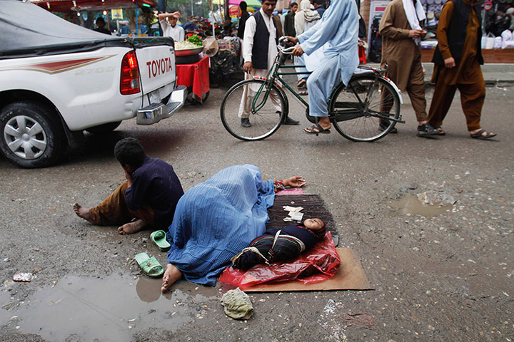 Picture Desk Live: An Afghan woman beggar sleeps on the street