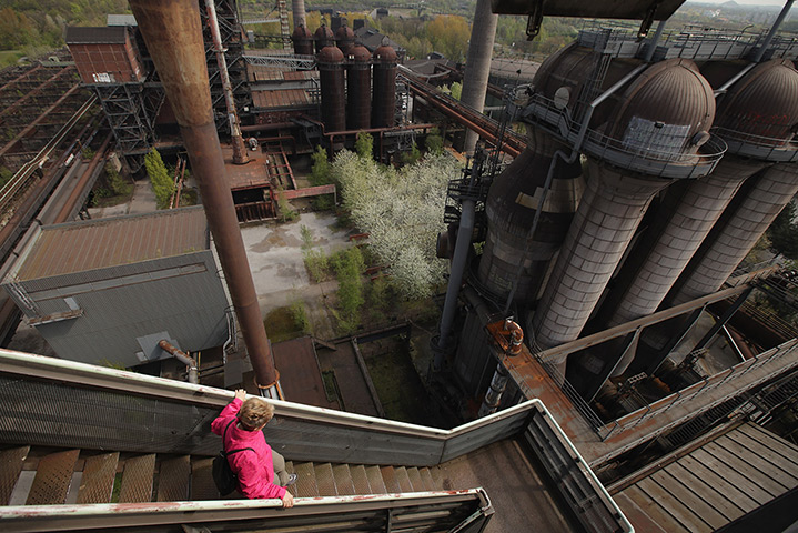 24 hours: Duisburg, Germany: A visitor climbs down steps at a former steelworks
