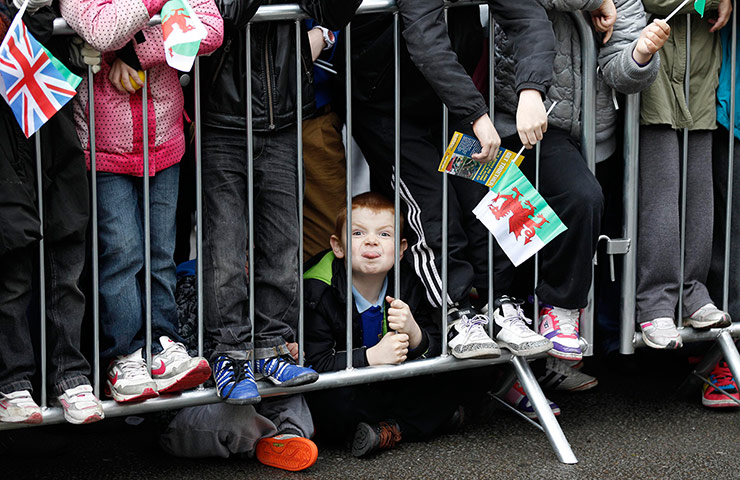 Picture Desk Live: A boy pokes out his tongue while waiting for the Queen
