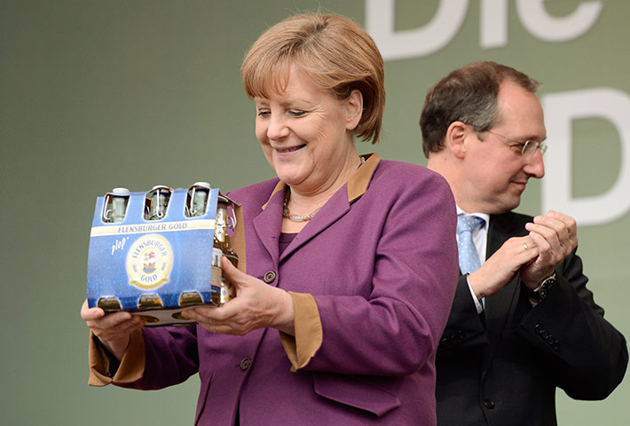 Picture Desk Live: German Chancellor Merkel smiles after she received beer 