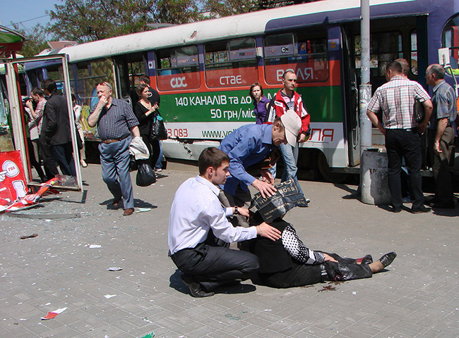Picture desk live: People assist an injured woman at the scene of an explosion in Ukraine