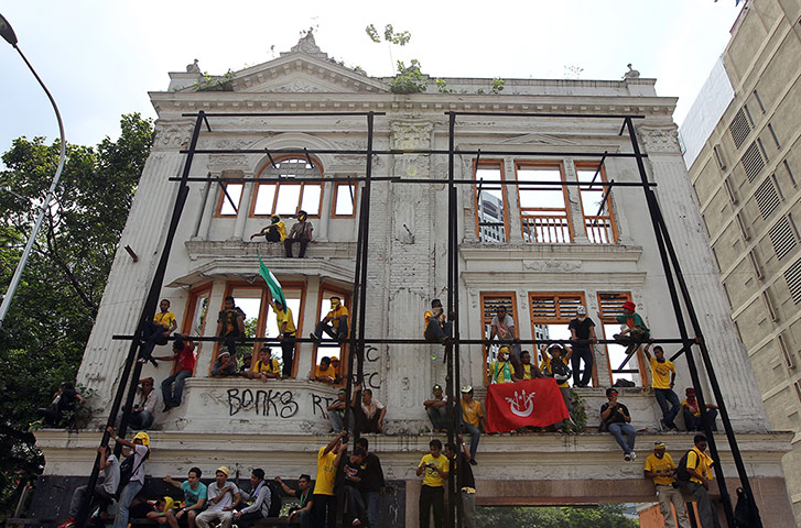 Kuala Lumpur: Protestors climb a building to avoid the water canon and tear gas