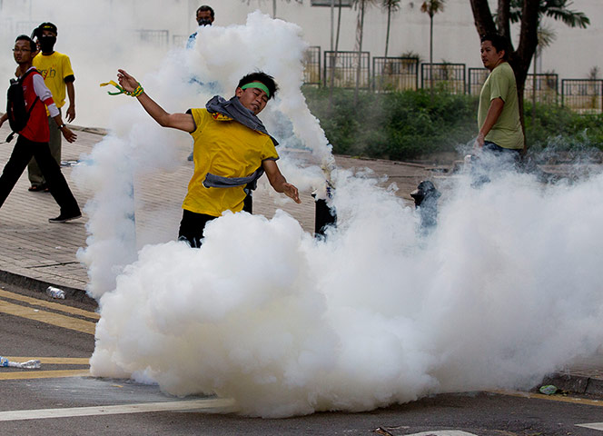 Kuala Lumpur: A protester is caught up in tear gas cloud
