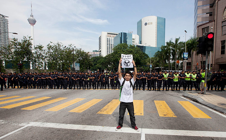 Kuala Lumpur: A lone protester stands in front of a line of police