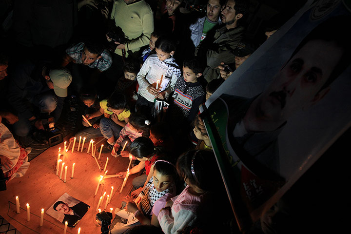 24 hours: Gaza City, Palestine: Children place candles on the ground during a demo