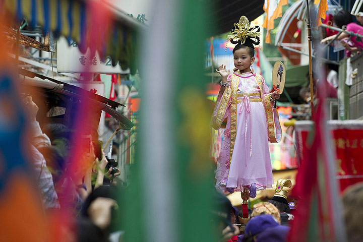 24 hours: Hong Kong, China: A young performer supported by hidden metal rods waves