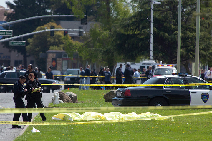 Oakland shooting: Oakland Police crime scene investigators stand over a number of bodies