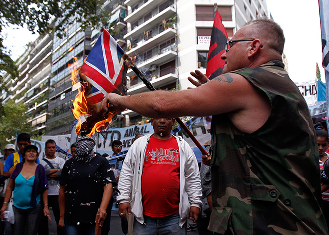 Falklands protests: An Argentine Falklands War veteran burns a Union Jack flag