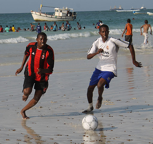 Somalia: Boys play football near the Lido beach