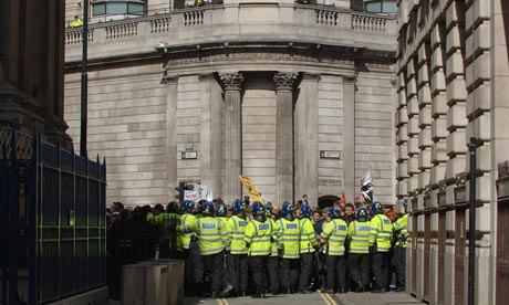 Riot police hold protesters