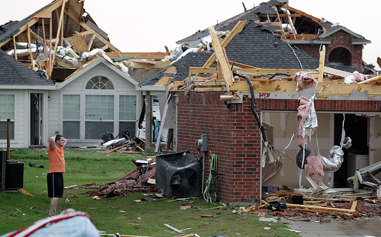 Texas tornado: An area resident surveys the damage to a home
