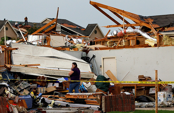 Texas tornado: April Bridges pauses while digging through the remains of house, Arlington