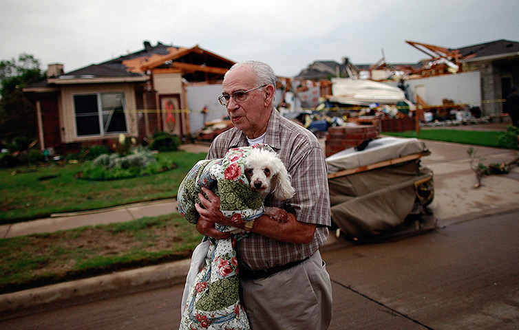 Texas tornado: David Lowe carries his dog after it was rescued from rubble in Arlington