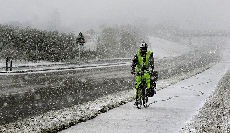 UK snow: A man cycling in south Derbyshire