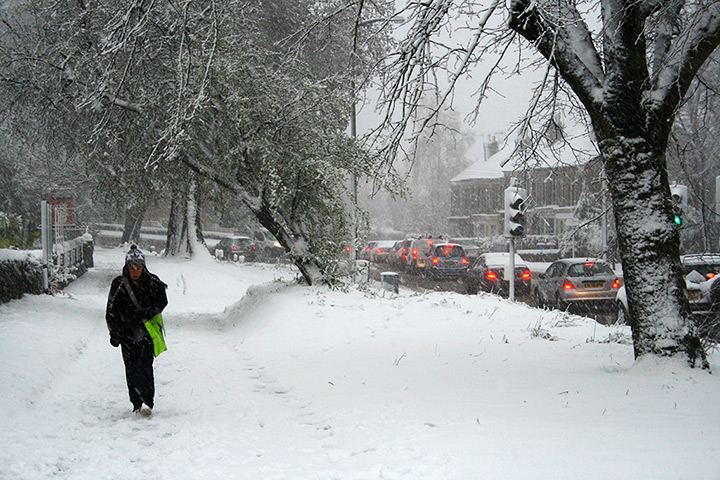UK snow: A paper boy makes his way through snow in the Crosspool, Sheffield