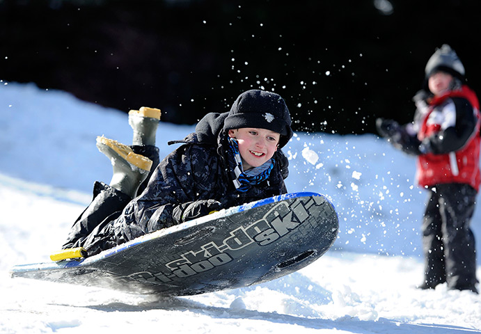 UK snow: Eilidh Gunn enjoys sledging in Aviemore, Scotland