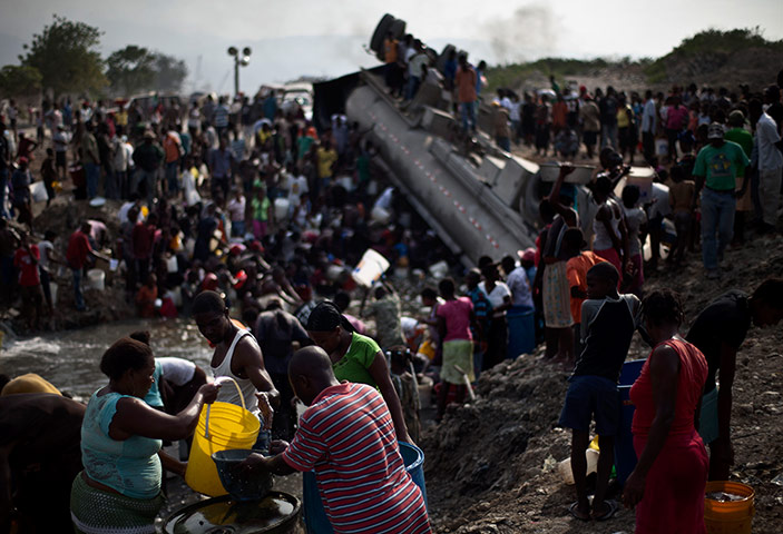 Haiti: People collect fuel in Haiti