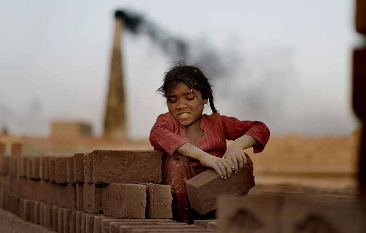 24 Hours: Islamabad, Pakistan: Naginah Sadiq, 5, arranges bricks