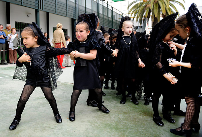 Holy Week: Young girls wear the traditional black mantillas 