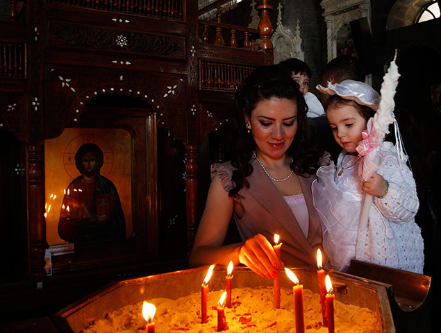 Holy Week: A woman holds a lit candle