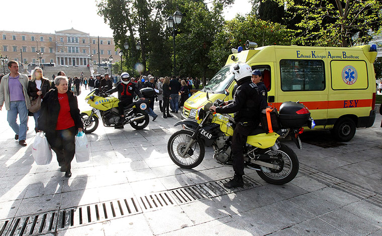 Greece unrest: An ambulance carries the body of an elderly man who commited suicide