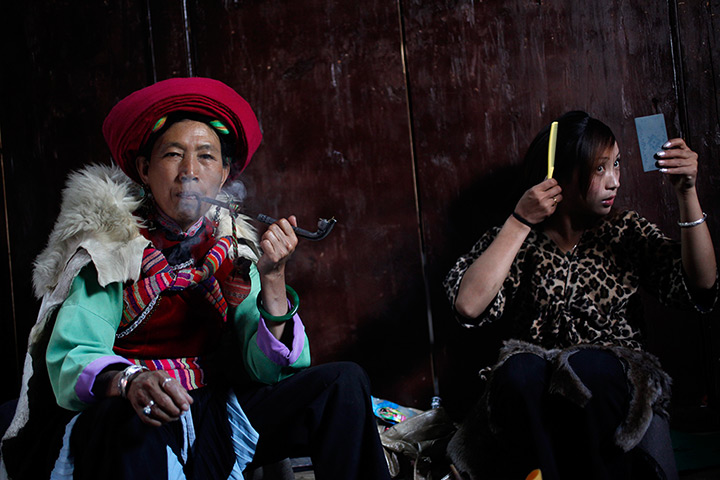 FTA: How Hwee Young: A veteran performer of the Naxi ethnic minority smokes her pipe backstage